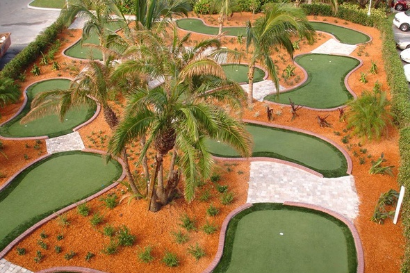 Vancouver Aerial view of a mini golf course with synthetic grass and palm trees.